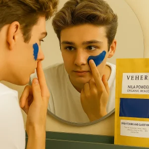 Teenage boy applying blue VEHERA NILA Powder face mask while looking in the mirror with the product pouch visible in the foreground